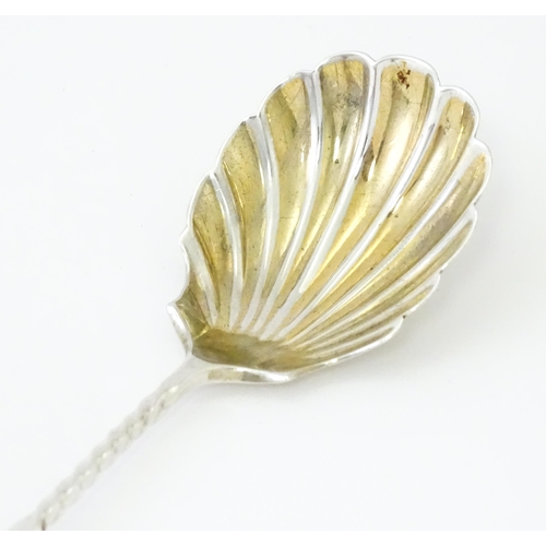 513 - A Victorian silver sugar spoon with shell formed bowl and openwork detail, hallmarked London 1894, m... 