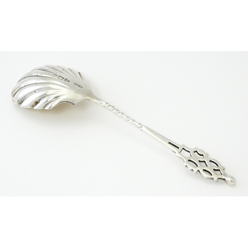 513 - A Victorian silver sugar spoon with shell formed bowl and openwork detail, hallmarked London 1894, m... 