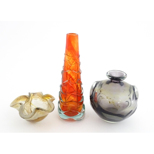 216 - Three Mdina glass items comprising an orange Helter Skelter style vase, a pulled ear vase and an Ear... 