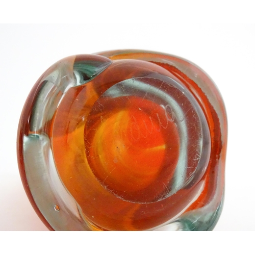 216 - Three Mdina glass items comprising an orange Helter Skelter style vase, a pulled ear vase and an Ear... 
