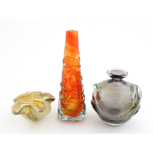 216 - Three Mdina glass items comprising an orange Helter Skelter style vase, a pulled ear vase and an Ear... 