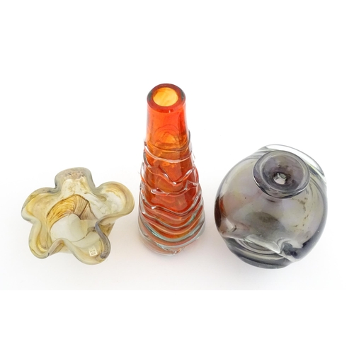 216 - Three Mdina glass items comprising an orange Helter Skelter style vase, a pulled ear vase and an Ear... 
