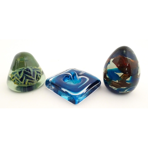 219 - Three Mdina glass items comprising a dump paperweight with chevron detail, a Tiger pattern paperweig... 