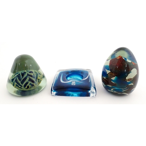 219 - Three Mdina glass items comprising a dump paperweight with chevron detail, a Tiger pattern paperweig... 