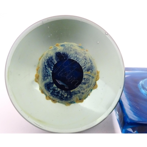 219 - Three Mdina glass items comprising a dump paperweight with chevron detail, a Tiger pattern paperweig... 