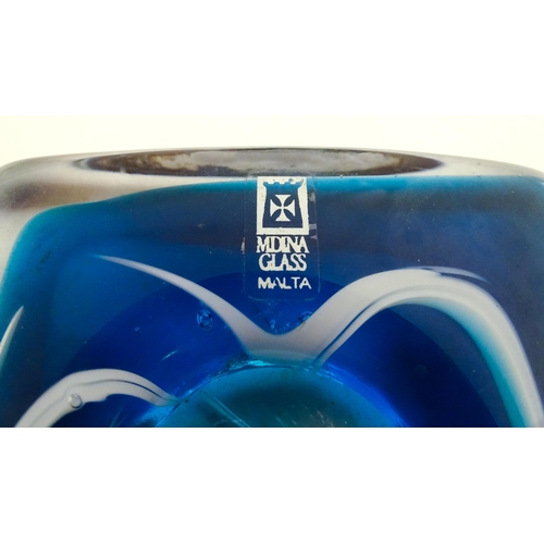 219 - Three Mdina glass items comprising a dump paperweight with chevron detail, a Tiger pattern paperweig... 