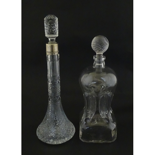 230 - Two decanters, one with Russian silver collar, the other with pinch detail. The tallest approx 13