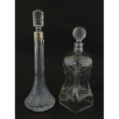 230 - Two decanters, one with Russian silver collar, the other with pinch detail. The tallest approx 13
