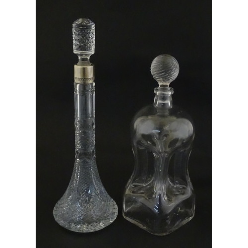 230 - Two decanters, one with Russian silver collar, the other with pinch detail. The tallest approx 13