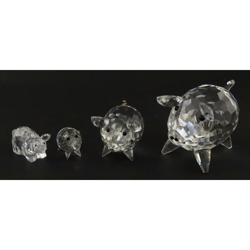 304 - Four Swarovski crystal models of pigs. Largest approx. 2 3/4