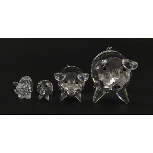 304 - Four Swarovski crystal models of pigs. Largest approx. 2 3/4