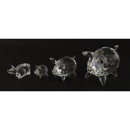304 - Four Swarovski crystal models of pigs. Largest approx. 2 3/4