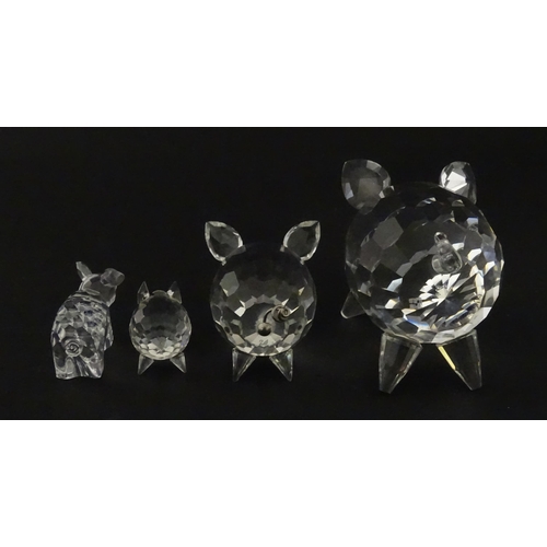 304 - Four Swarovski crystal models of pigs. Largest approx. 2 3/4