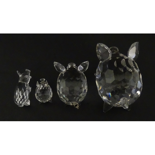 304 - Four Swarovski crystal models of pigs. Largest approx. 2 3/4