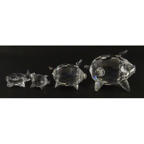 304 - Four Swarovski crystal models of pigs. Largest approx. 2 3/4