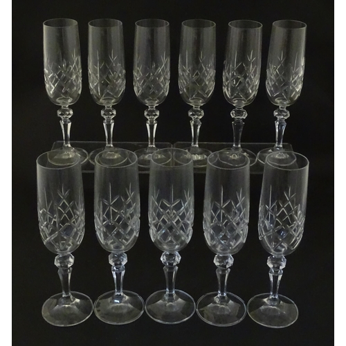 312 - Eleven cut glass champagne flutes. Approx. 8 1/2