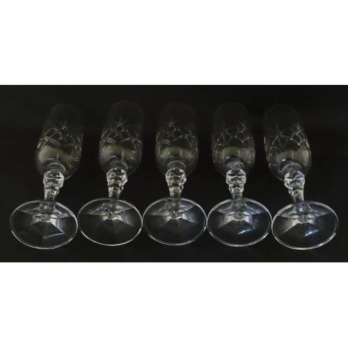 312 - Eleven cut glass champagne flutes. Approx. 8 1/2