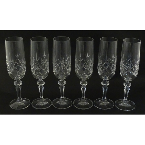 312 - Eleven cut glass champagne flutes. Approx. 8 1/2