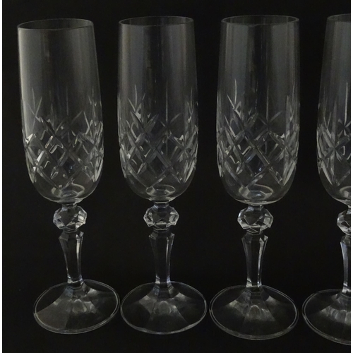 312 - Eleven cut glass champagne flutes. Approx. 8 1/2