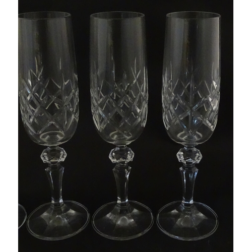 312 - Eleven cut glass champagne flutes. Approx. 8 1/2
