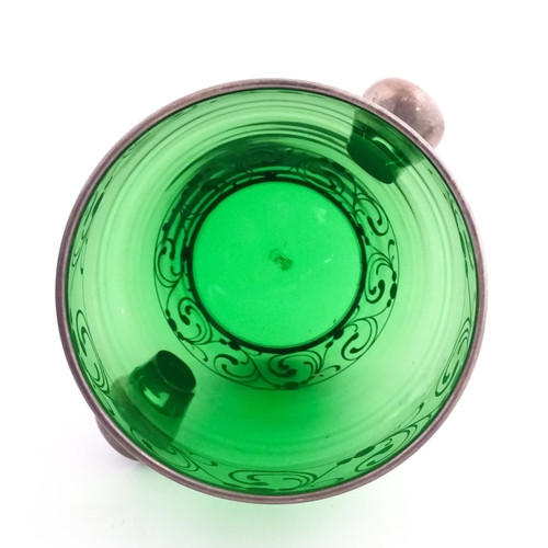315 - A Spanish green glass punch bowl with ladle and six punch cups with silvered overlay detail. Marked ... 