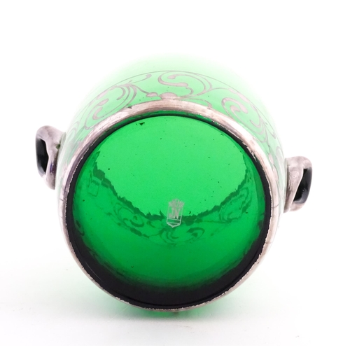 315 - A Spanish green glass punch bowl with ladle and six punch cups with silvered overlay detail. Marked ... 