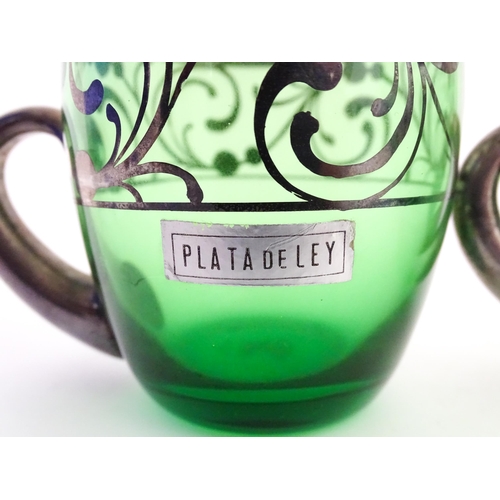 315 - A Spanish green glass punch bowl with ladle and six punch cups with silvered overlay detail. Marked ... 