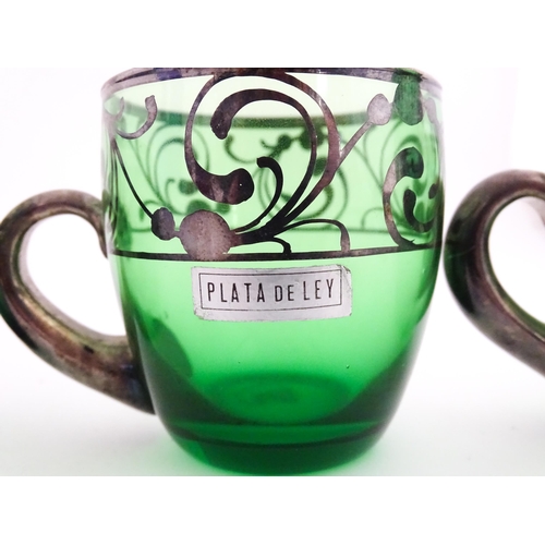 315 - A Spanish green glass punch bowl with ladle and six punch cups with silvered overlay detail. Marked ... 