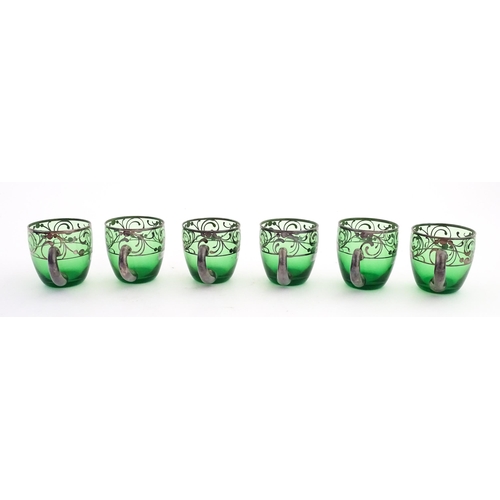 315 - A Spanish green glass punch bowl with ladle and six punch cups with silvered overlay detail. Marked ... 