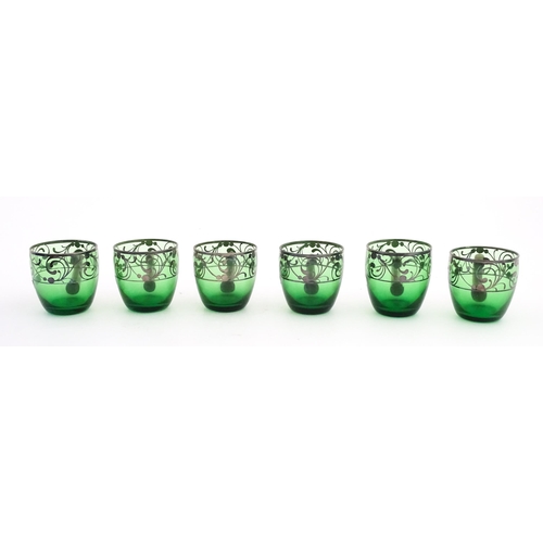 315 - A Spanish green glass punch bowl with ladle and six punch cups with silvered overlay detail. Marked ... 