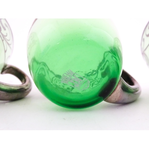 315 - A Spanish green glass punch bowl with ladle and six punch cups with silvered overlay detail. Marked ... 