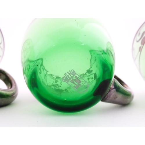 315 - A Spanish green glass punch bowl with ladle and six punch cups with silvered overlay detail. Marked ... 