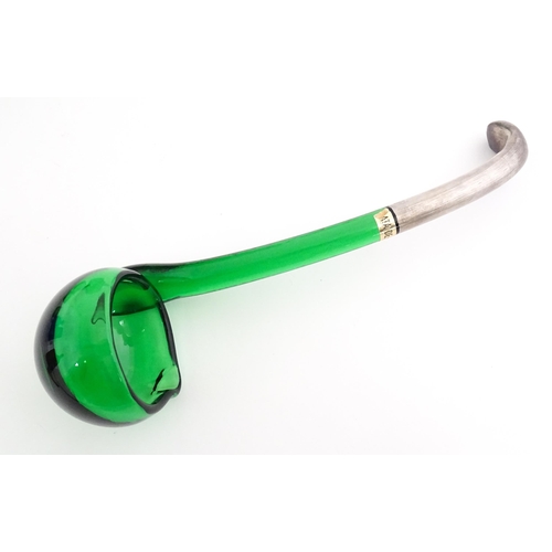 315 - A Spanish green glass punch bowl with ladle and six punch cups with silvered overlay detail. Marked ... 