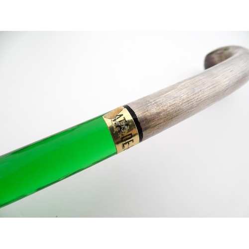 315 - A Spanish green glass punch bowl with ladle and six punch cups with silvered overlay detail. Marked ... 