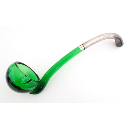 315 - A Spanish green glass punch bowl with ladle and six punch cups with silvered overlay detail. Marked ... 