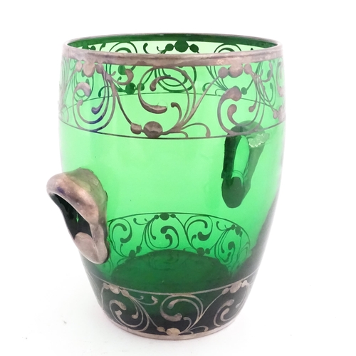 315 - A Spanish green glass punch bowl with ladle and six punch cups with silvered overlay detail. Marked ... 
