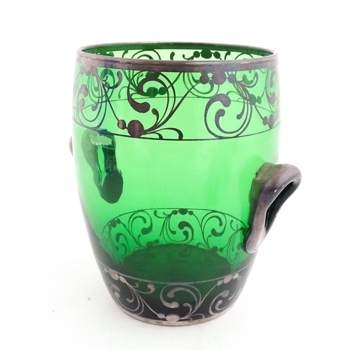 315 - A Spanish green glass punch bowl with ladle and six punch cups with silvered overlay detail. Marked ... 