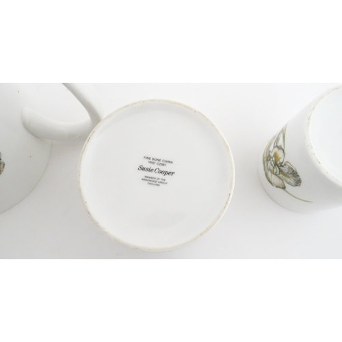 206 - A Susie Cooper coffee set decorated in the Iris pattern comprising coffee pot, sugar bowl, milk jug,... 