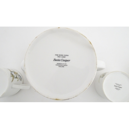 206 - A Susie Cooper coffee set decorated in the Iris pattern comprising coffee pot, sugar bowl, milk jug,... 