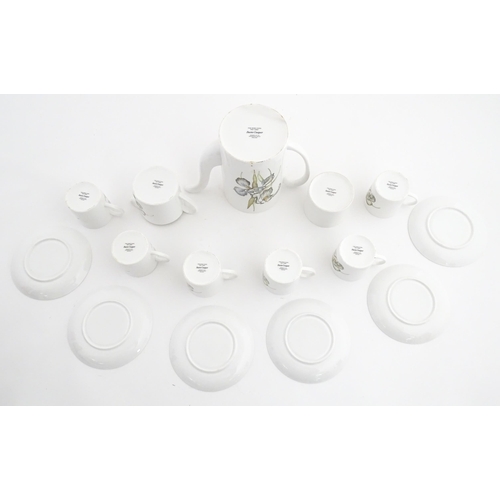 206 - A Susie Cooper coffee set decorated in the Iris pattern comprising coffee pot, sugar bowl, milk jug,... 