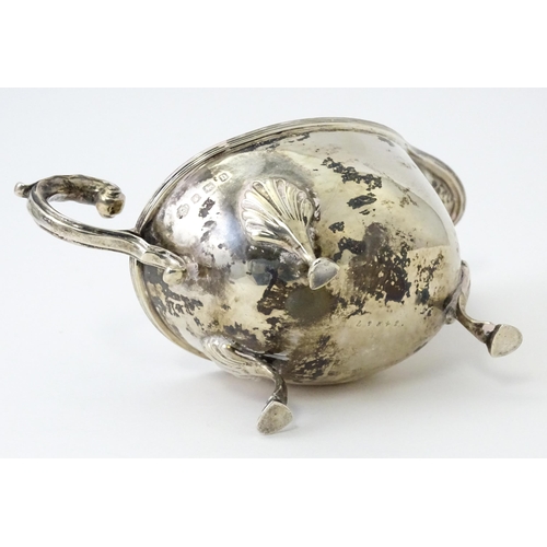 325 - A silver sauce boat raised on three feet with a scroll handle, hallmarked Sheffield 1930, maker Will... 