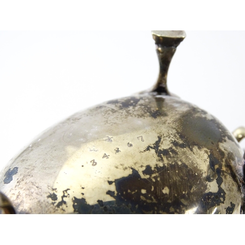 325 - A silver sauce boat raised on three feet with a scroll handle, hallmarked Sheffield 1930, maker Will... 