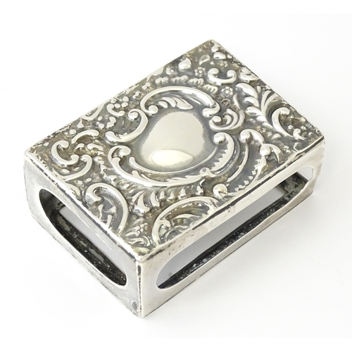 327 - A silver match box cover with embossed decoration, hallmarked Chester 1907. Approx 2 1/4