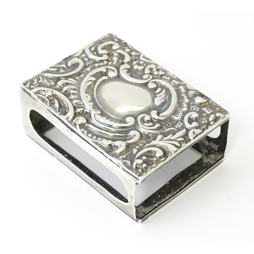 327 - A silver match box cover with embossed decoration, hallmarked Chester 1907. Approx 2 1/4