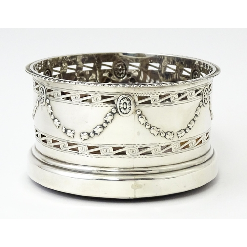 333 - A silver wine coaster with turned wooden base and swag detail, hallmarked Chester 1905, maker George... 