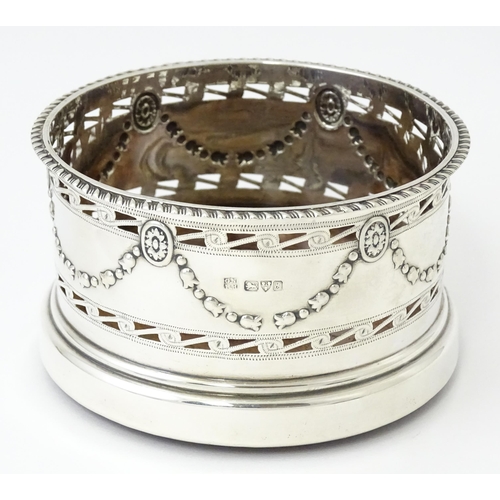 333 - A silver wine coaster with turned wooden base and swag detail, hallmarked Chester 1905, maker George... 