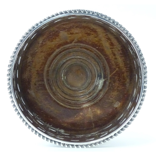 333 - A silver wine coaster with turned wooden base and swag detail, hallmarked Chester 1905, maker George... 