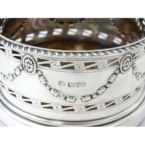 333 - A silver wine coaster with turned wooden base and swag detail, hallmarked Chester 1905, maker George... 