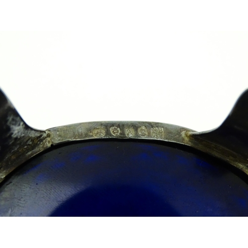 339 - A set of three George III silver salts of oval form with pierced decoration and blue glass liners, h... 