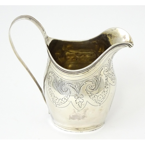 342 - A silver cream jug with engraved decoration, hallmarked London 1802, maker Peter, Ann & William Bate... 
